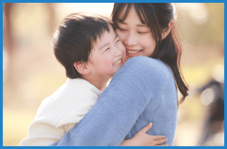 Self-regulation. What is it and why is it important blog feature image a mother and son smile and hug.