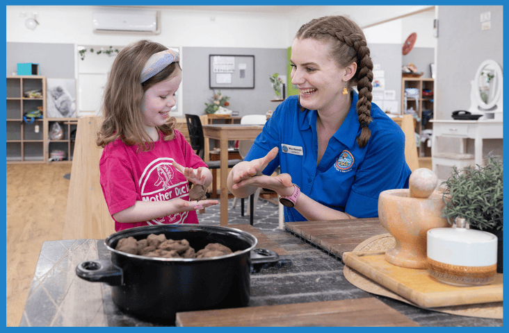 Child and staff member at Mother Duck Child Care engaging in activity.